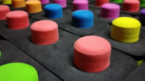 Multicolored big buttons on a black background close up Stock Footage 145731193