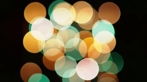 Multicolored blinking bokeh on a black background Stock Footage 141417745