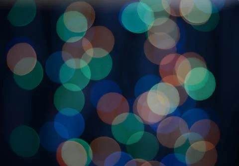 Multicolored bokeh on the black background Stock Photos