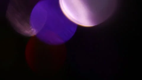 Multicolored bokeh moving to the left in the dark 스톡 동영상 309827261