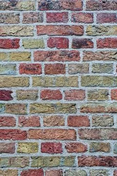 Multicolored brick wall texture with old mortar Stock Photos
