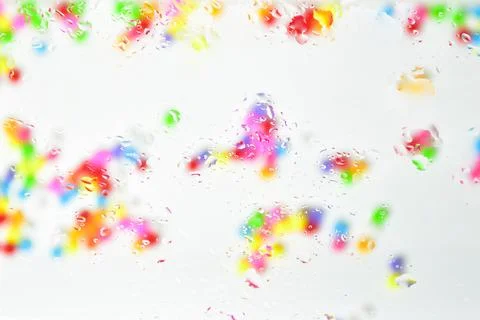 Multicolored bright abstract background. Blurry balls are visible through t.. Stock Photos