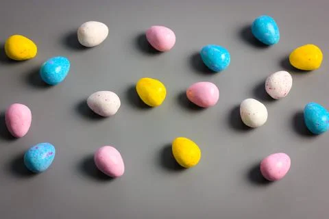 Multicolored bright Easter chocolate eggs yellow, white, pink, blue colors Stock Photos