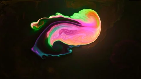 Multicolored bright paints move in a liquid with a glow. Stock Footage 247777106
