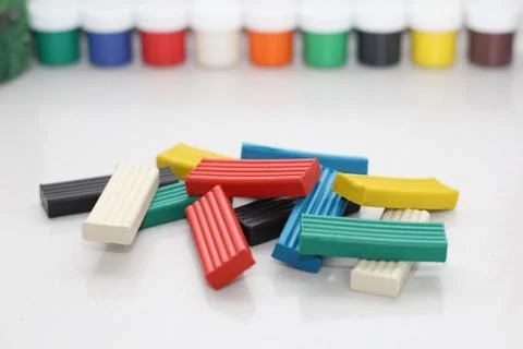 Multicolored bright plasticine on a white background. Stock Photos