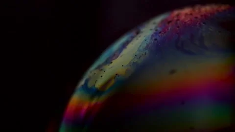 Multicolored bubble surface in motion isolated on black Stock Footage 154627991