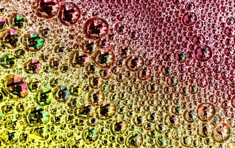 Multicolored bubbles on the surface of a pool of water create an abstract pie Stock Photos