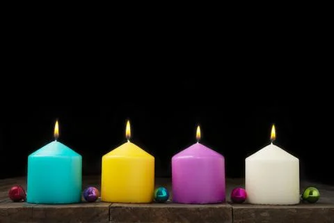 Multicolored burning candles Stock Photos