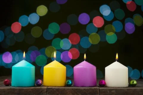 Multicolored burning candles Stock Photos