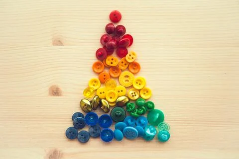 Multicolored buttons in form of triangle, christmas tree. Color rainbow butto Stock Photos