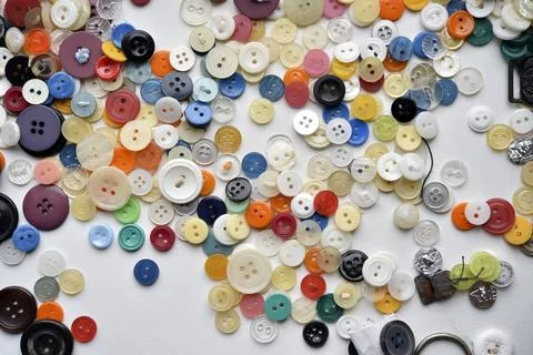 Multicolored buttons on a white background. Round buttons from clothes. Stockfoto's