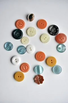 Multicolored buttons on a white background. Round buttons from clothes. Stockfoto's