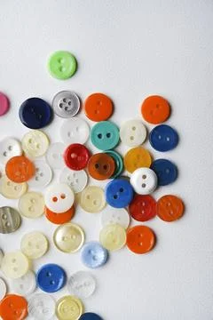 Multicolored buttons on a white background. Round buttons from clothes. Stockfoto's