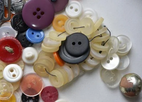 Multicolored buttons on a white background. Round buttons from clothes. Stockfoto's