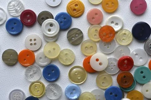Multicolored buttons on a white background. Round buttons from clothes. Stockfoto's