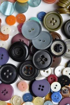 Multicolored buttons on a white background. Round buttons from clothes. Stockfoto's