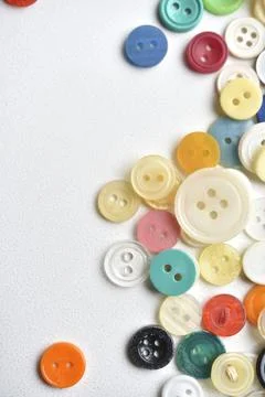 Multicolored buttons on a white background. Round buttons from clothes. Stockfoto's