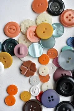 Multicolored buttons on a white background. Round buttons from clothes. Stockfoto's