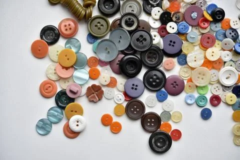 Multicolored buttons on a white background. Round buttons from clothes. Stockfoto's