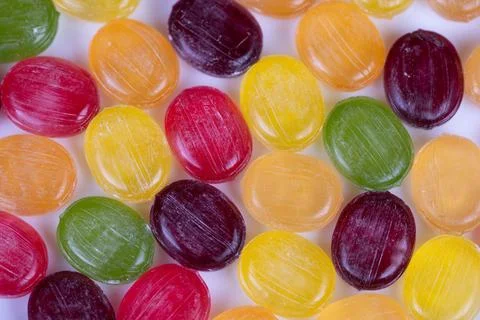 Multicolored candies form rhythmic pattern under macro lens, repeating circ.. 스톡 사진