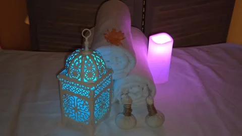Multicolored candles and towels make a beautiful massage composition on a light  Stock Footage 317117549