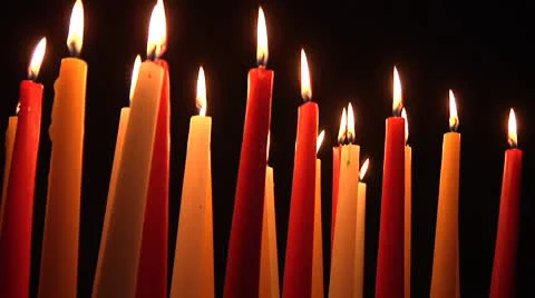 Multicolored candles burning in the dark on rotating display Видео 8961378