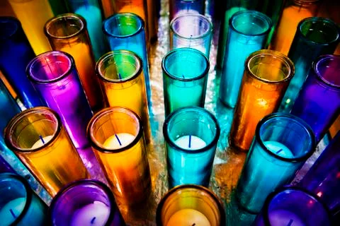 Multicolored candles in a cathedral. Stock Photos
