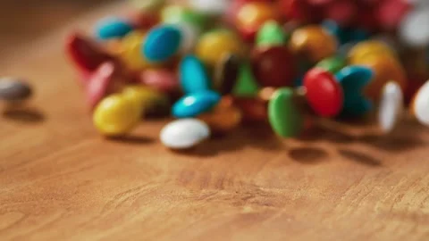Multicolored candy balls and a tree floor pass in front of the camera. Video stock 140508856