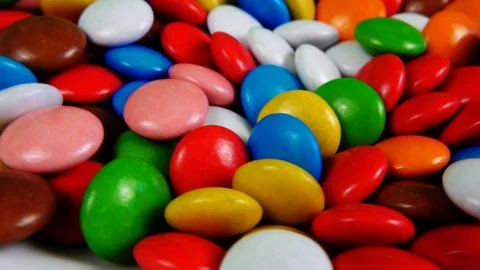 Multicolored candy, dragee on a plate, close-up. Video stock 93434096