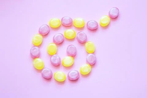 Multicolored candys on a colored background Stock Photos