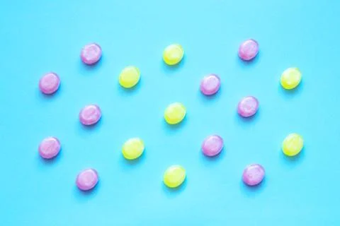 Multicolored candys on a colored background Stock Photos