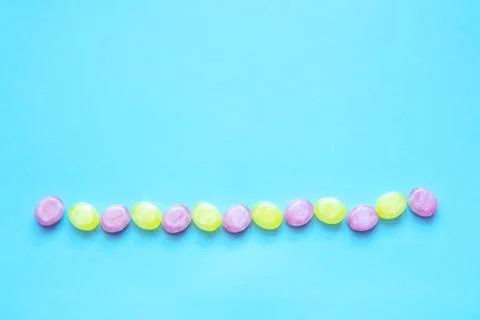 Multicolored candys on a colored background Stock Photos