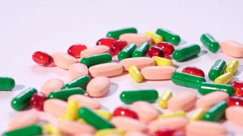 Multicolored capsules are scattered on a background Stock Footage 263805921