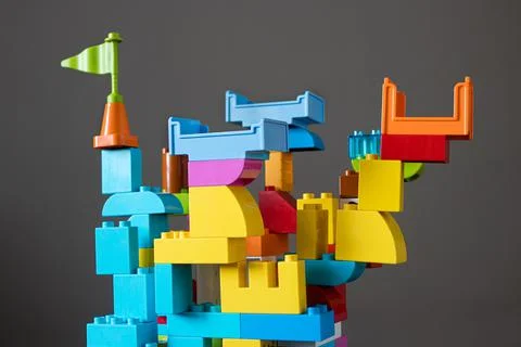 The multicolored castle is a structure made of colored designer constructor. Stock Photos