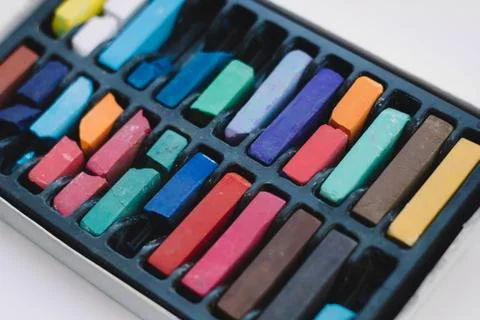 Multicolored chalks in a box close up Stock Photos