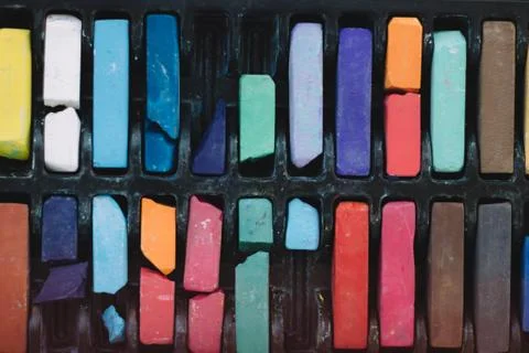 Multicolored chalks in a box close up Stock Photos