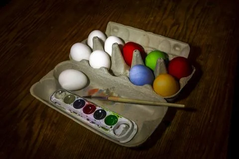 Multicolored chicken eggs for Easter and paints Stock Photos