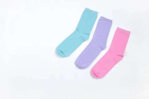 Multicolored children's socks without pattern, laid out in corner of frame, o Stock Photos