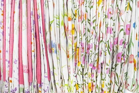 Multicolored chintz fabrics with botanical patterns folded tightly next to .. Foto stock