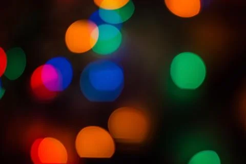 Multicolored circles on black. Stock Photos