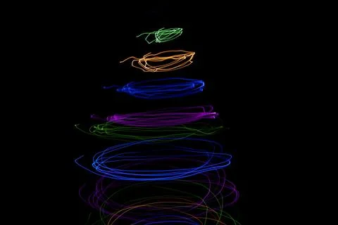 Multicolored circular lights on a black background Stock Photos