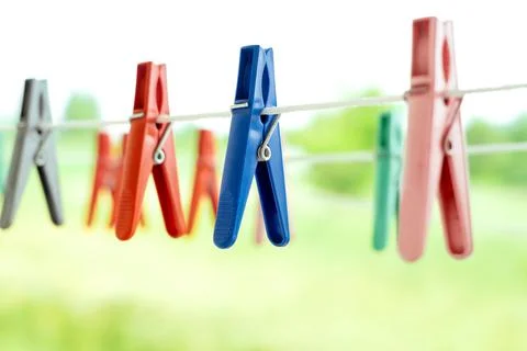 Multicolored clothespins for drying clean laundry hang in nature Stock Photos