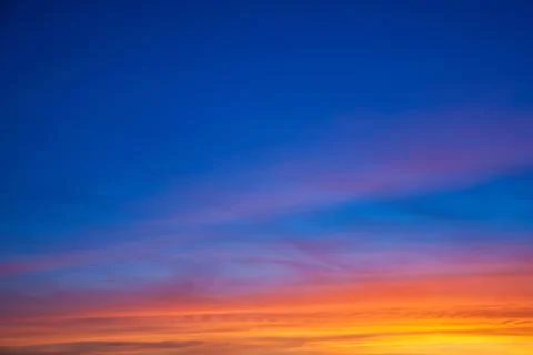 Multicolored clouds and sky at sunset Stock Photos