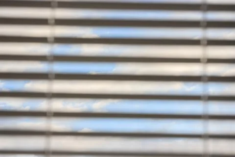 Multicolored clouds at dawn, view through the blinds. bright sky filled with  Stock Photos