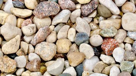 Multicolored coarse rounded stones as a background Stock Photos