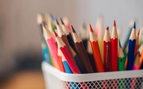 Multicolored colored pencils on a blurred background, children's creativity Stock Photos