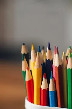 Multicolored colored pencils on a blurred background, children's creativity Stock Photos