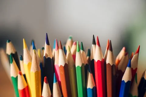 Multicolored colored pencils on a blurred background, children's creativity Stock Photos