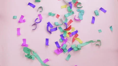 Multicolored confetti falling on a pink background Stock Footage 112179984