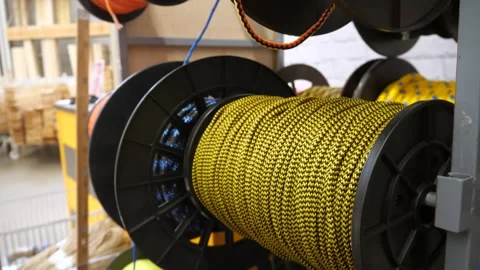 Multicolored cords, orange, yellow, blue, wound on spools. Stock-Footage 304987573